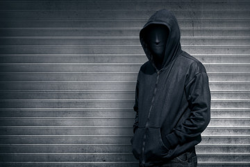 Anonymous man on grey shutter door