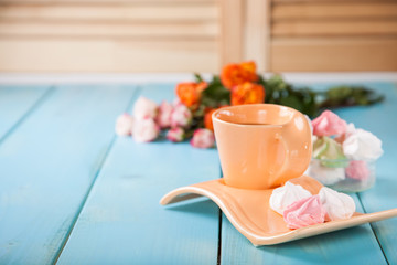 Romantic breakfast - zephyr, tea and roses on a table. Selective focus. Copy space.