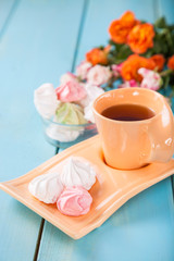 Romantic breakfast - zephyr, tea and roses on a table. Selective focus. Copy space.