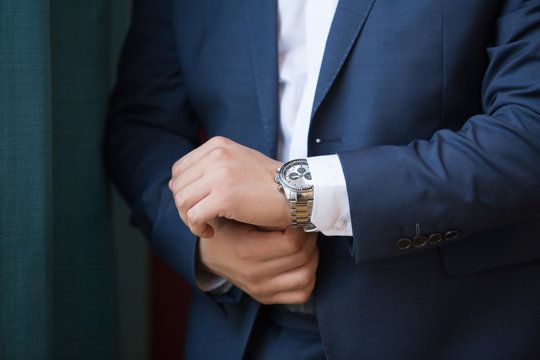 A close up of an expensive elegant watch on a hand of the business man. business concept