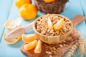 muesli and tangerines on a table, selective focus, copy space