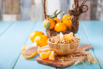 muesli and tangerines on a table, selective focus, copy space