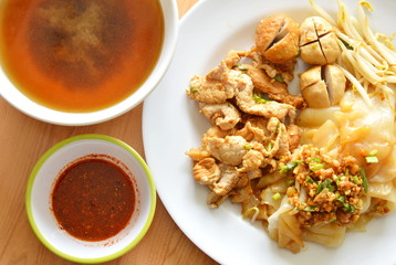 dry rice noodle paste topping pork ball and soup with chili sauce