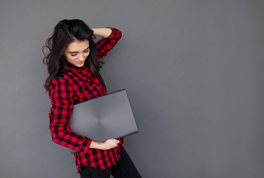 Casual Young Woman Holding A Brand New Laptop