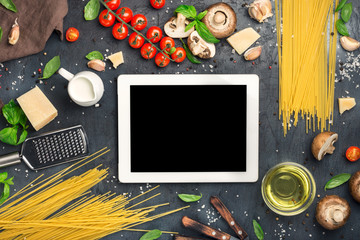 Tablet with copy space with ingredients for cooking Italian past