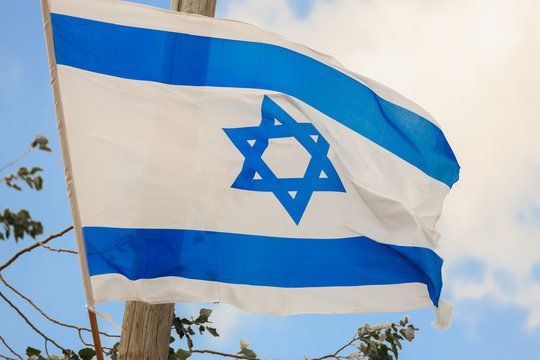 Flag of Israel over the sky at wind