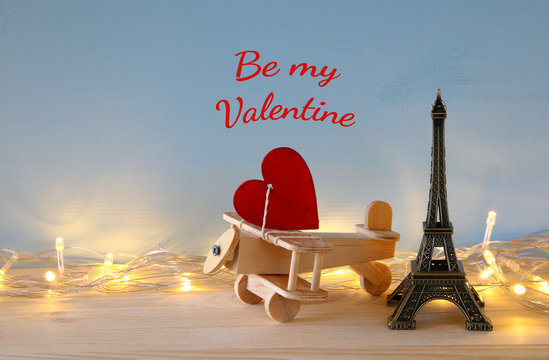 Wooden plane with heart next to Eiffel Tower