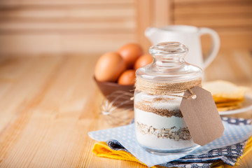Сookies ingredients in a glass jar. Selective focus. Copy space