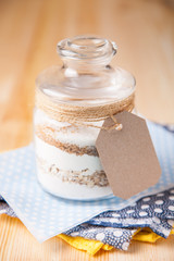 Сookies ingredients in a glass jar. Selective focus. Copy space
