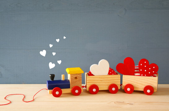 Wooden toy train with hearts on the table
