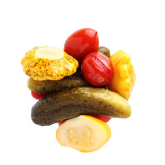 Assorted vegetables in a glass jar isolated on white background