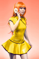 Young asian woman posing in yellow dress with donut headphones