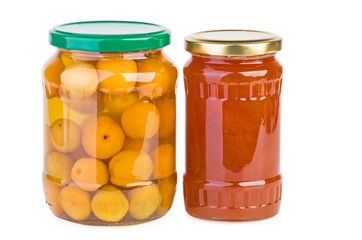 Glass jars with preserved apricots and jam