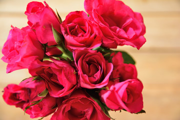 red roses on wooden table