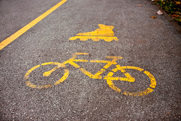 Signs cycling and inline skating track on the asphalt