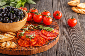 Spanish traditional chorizo sausage with fresh herbs, olives, to