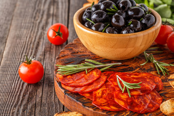 Spanish traditional chorizo sausage with fresh herbs, olives, to