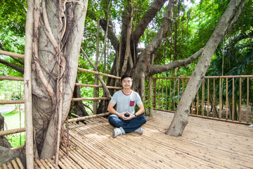 The man do meditation on the tree house