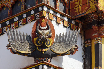Obraz premium Garuda. Colorized Wooden carving on the ancient medieval Buddhist temple of Tibetan style, Kathmandu, Nepal. Architectural detail of exterior wall.