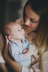 Newborn baby on his mother's hands