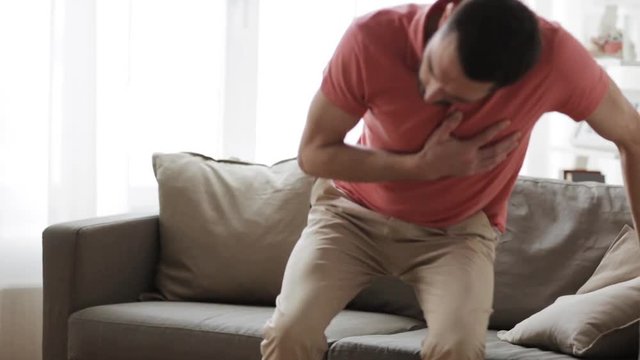 unhappy man suffering from heart ache at home