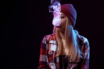 young woman smoking electronic cigarette