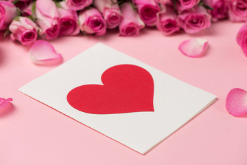 Valentine's Day greeting card with rose flowers over pink backgr