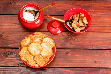 Belarusian traditional cuisine: potato pancakes with fried bacon