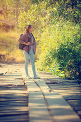 Woman tourist with backpack in nature