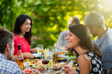 Group of friends lunching around a table on a terrace