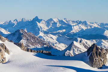 Fototapeta na wymiar Ski resort Chamonix Mont Blanc. The mountain is the highest in the alps and the European Union. Alpine mountains range landscape in beauty French, Italian and Swiss ALPS seen from Aiguille du Midi