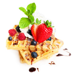 Delicious  Belgian waffles with whipped cream, mint leaf, strawb