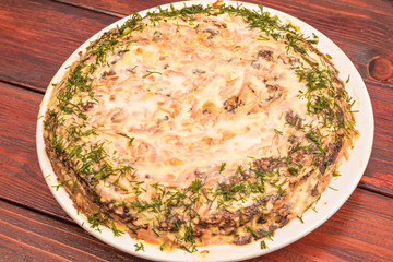 Layer cake of individual liver pancakes and omelets with carrots