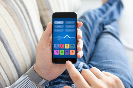 man holding phone with app smart home