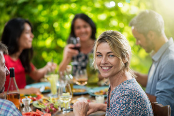 beautiful woman lunching with friends on a terrace table