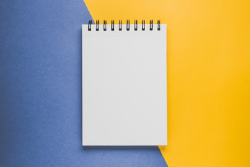 Notebad or sketchbook  on the yellow-blue background. Creativity