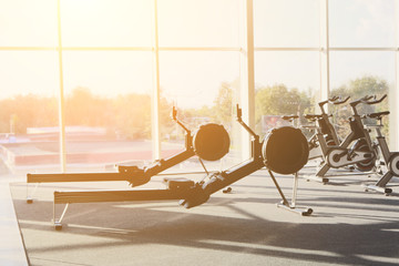 Modern gym interior with equipment, fitness leg exercise machine