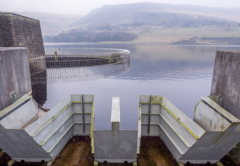 Unusual design of spillway at the Dove stones reservoir on a cloudy winters January day. Oldham, Saddleworth, UK