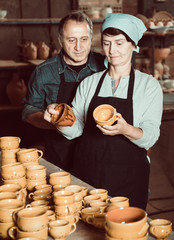Elderly potters at ceramic workshop.