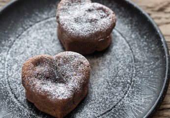 Fototapeta na wymiar Chocolate lava cakes in the shape of heart