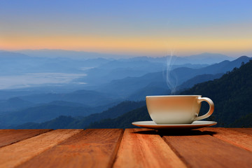 Morning cup of coffee or tea with mountain background at sunrise