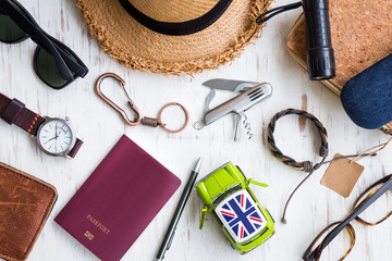 Travel preparations concept, men's accessories and passport on white rustic wooden background