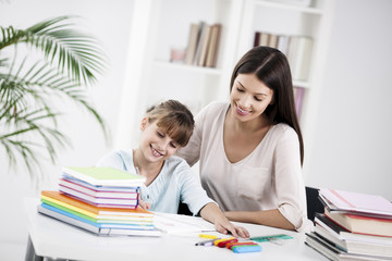 Fototapeta premium Mother and Daughter Doing Homework Together