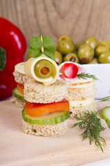 Fototapeta na wymiar finger food with bread, peppers, cucumber, cheese and olives