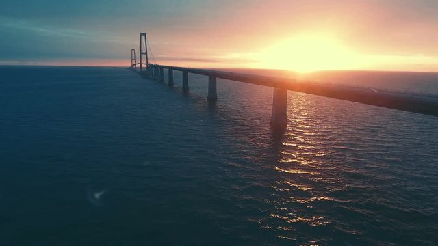Aerial view of large bridge over the sea at evening. Danish great belt bridge at sunset.