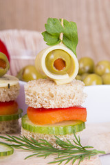 finger food with bread, peppers, cucumber, cheese and olives