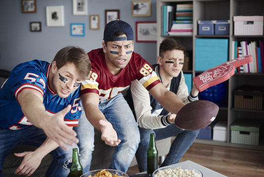 Unhappy men while watching American football