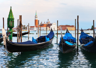 Fototapeta na wymiar Venetian gondolas near the pier of San Marco in the background of the island of San Giorgio Maggiore. Venice, Italy