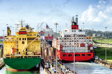 panama canal,  a cargo ship entering the miraflores locks in the