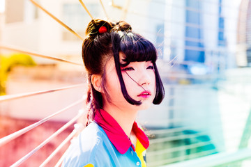 Half length portrait of young beautiful asian millennial woman outdoor in the city, overlooking...